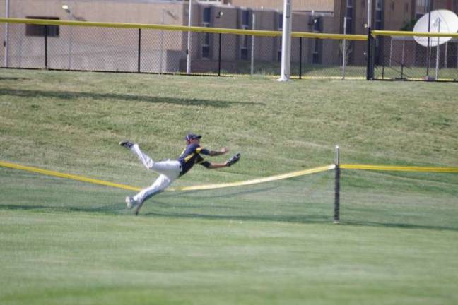 Warriors wear down Vikings Vernon outfielder Michael Suppa makes a catch at the outer limits of the field in the fourth inning. Suppa flipped over the fence as he made the catch. But officials ruled it a home run claiming Suppa extended the field of play.
