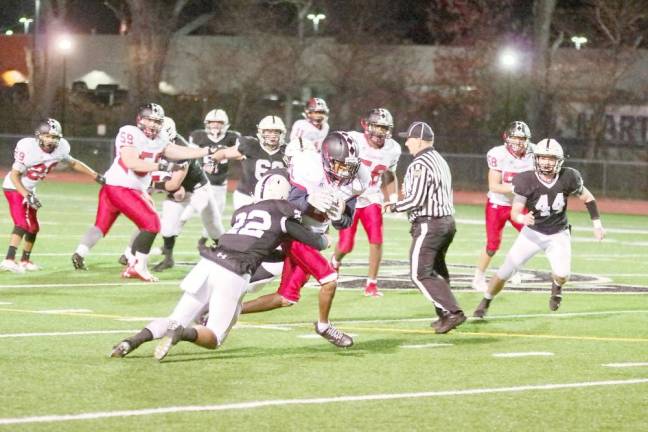 A Delaware Valley defender grabs a Williamsport ball carrier in the first half.