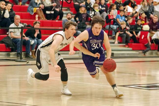 Delaware Valley Warriors hold off Wallenpaupack Buckhorns Wallenpaupack's Derrick Vosburg dribbles the ball while covered by Delaware Valley's Tyler Magee in the fourth period. (Photo by George Leroy Hunter)
