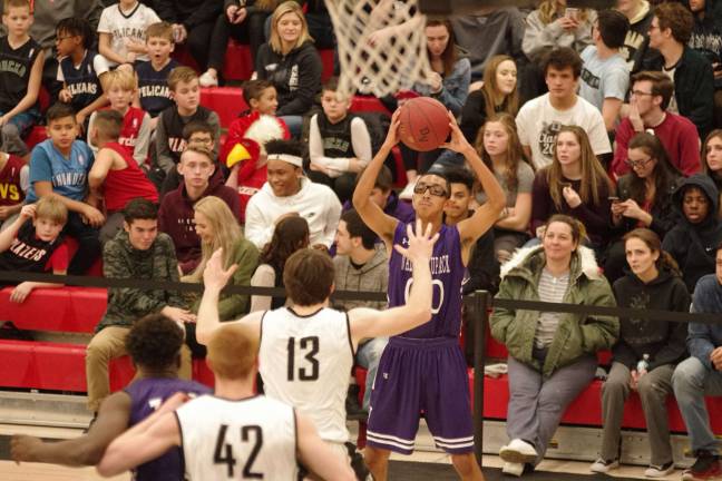 Wallenpaupack's Izaiah Santiago holds the ball as he looks for an open teammate to pass to. (Photo by George Leroy Hunter)
