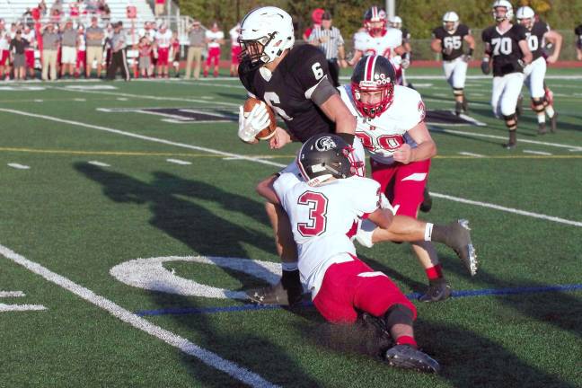 Delaware Valley ball carrier Jason Henderson breaks through two North Pocono defenders in the fourth quarter. Henderson scored two rushing touchdowns.