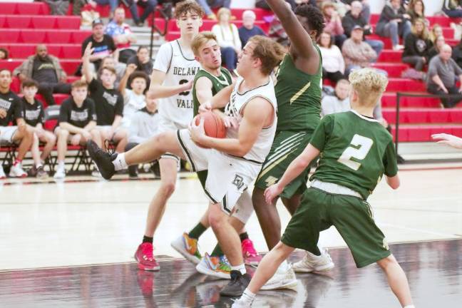 Delaware Valley's Lukas Schutz holds the ball after grabbing it during a rebound late in the game. Schutz scored 4 points.