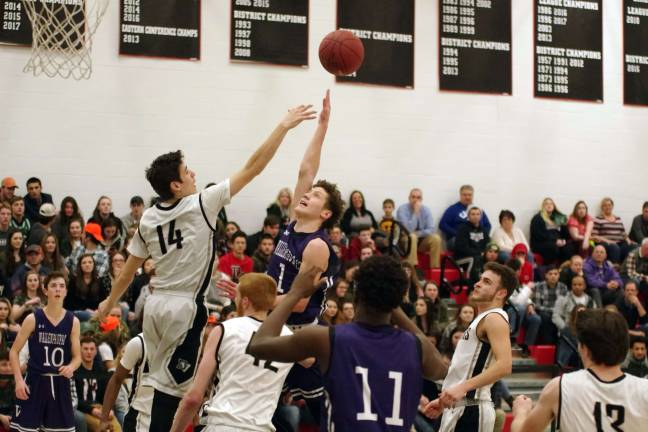 Delaware Valley's Grant Berrios tries to block the ball during Wallenpaupack's Elijah Rosenthal's (1) shot attempt in the fourth period. Rosenthal scored seventeen points. (Photo by George Leroy Hunter)