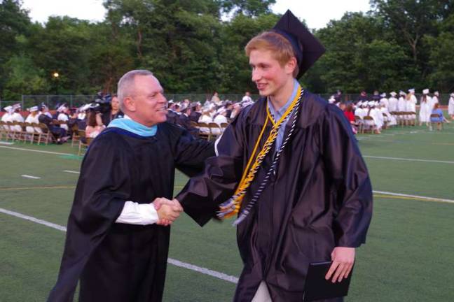 Delaware Valley graduates are all smiles Superintendent of Delaware Valley School District John Bell congratulates Senior Class Vice President Scott Brown.