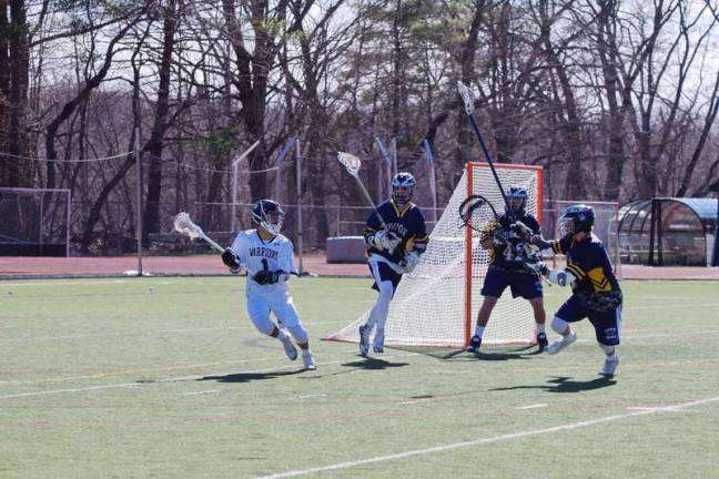 Vernon crushes DV in lacrosse Delaware Valley's Josh Balcarcel maneuvers the ball against the Vernon defense. Balcarcel scored his teams first goal of the game. (Photo by George Leroy Hunter)