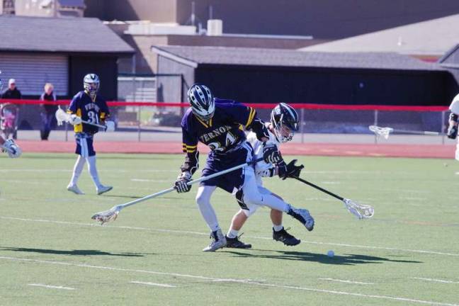 Vernon crushes DV in lacrosse A Vernon Viking and a Delaware Valley Warrior battle for control of the ball (Photo by George Leroy Hunter)