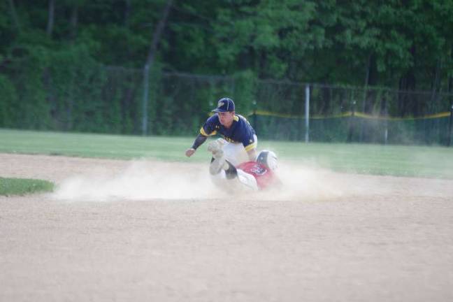 Warriors wear down Vikings The Vernon second baseman tags out a sliding Delaware Valley runner in the fourth inning.
