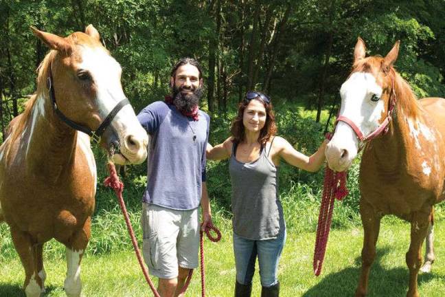 Cross-country horseback riders welcomed in Milford Noah Stellarious (left) and Bianca Scarano with their horses, Jessie and Chief (Photo courtesy Julio Olivencio)