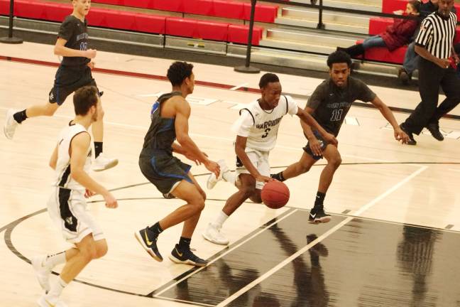 DV Warriors defeat Valley Central Vikings in holiday tournament Valley Central defenders try to keep pace with Delaware Valley ball handler Hassan Keys. Keys scored two points. (Photo by George Leroy Hunter)