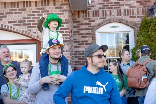 Lucas Hurtak of Port Jervis sits and cheers from his dad’s shoulders at the Port Jervis St. Patrick’s Day Parade. Photo by Sammie Finch