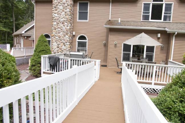 Upscale center hall colonial offers space and privacy Back decking