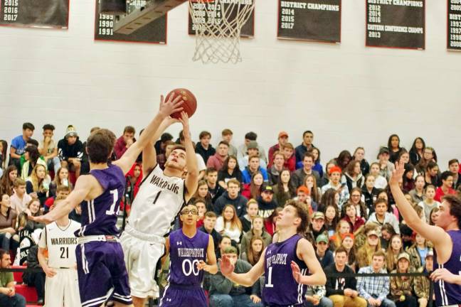 Delaware Valley's Dylan Kelly raises the ball towards the hoop in the first period. Kelly scored twelve points. (Photo by George Leroy Hunter)