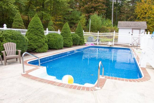 Upscale center hall colonial offers space and privacy Pool