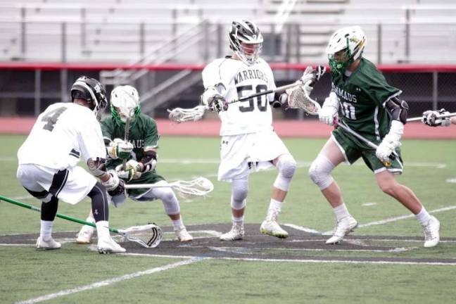 A weekend of DVHS lacrosse A Delaware Valley Warrior scoops up the ball with his crosse during a battle at the center of the field