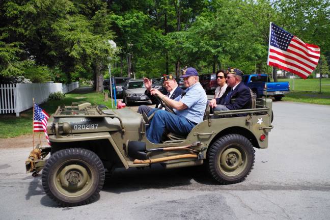 Remembering those who served Military veterans ride in a classic military jeep.