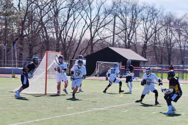 Vernon crushes DV in lacrosse The Delaware Valley Warriors and the Vernon Vikings maneuver near the goal post. (Photo by George Leroy Hunter)