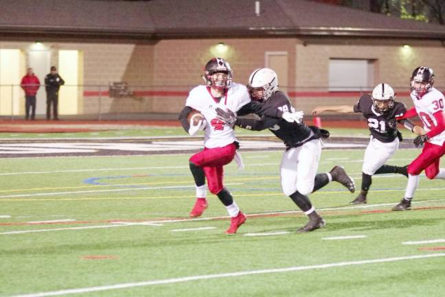 Williamsport ball carrier Brock Moyer is in the grasp of Delaware Valley defender James Staeckler in the first quarter. It was the beginning of a sack credited to Staeckler.