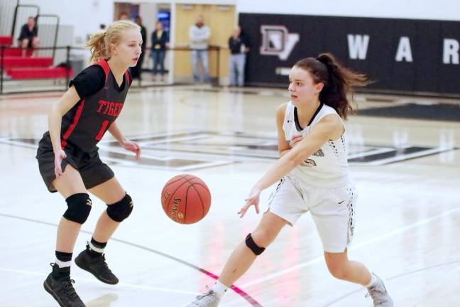 Delaware Valley's Ashley Thalassinos (white) passes the ball past Tunkhannock's Courtney Yuhas in the third quarter. Thalassinos scored 6 points.