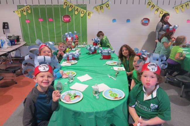 Seuss on the loose at DVES Mrs. Ross’s first-grade eating green eggs and ham (from left): Jaden Aragona, Hailey Burakowski, Raymond Leimkuhler, John Helt, Zara Shahee, John Osterhout, Daisy Olive Heller, Russell Bloomer, and Trent Kaylor (Photo by Peg Snure)