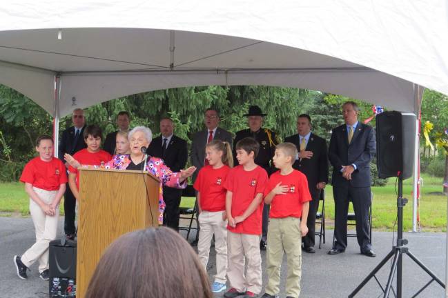 DVE-TV student-reporters attend 9/11 memorial service Singing "God Bless America" with Catherine Westfall (from left): Ava McAveney, Sydney Garrison, Katharine Quinn, Catherine Westfall, Kaylee Kurcon, Samuel Yost, and Ben Bailor (Photo provided)