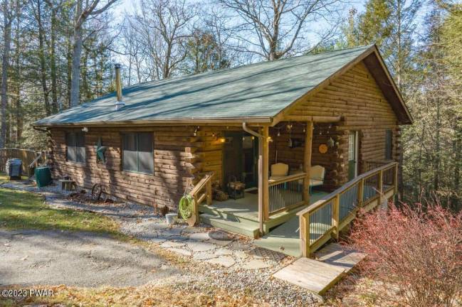 Custom log home offers lake access and privacy