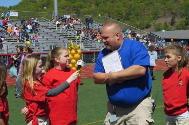 Special Olympics comes to DV Mr. Aaron Weston, Principal of Special Education, was asked about his job. He said he works with and truly enjoys working for special needs children. From left: Ryan O’Connor, Mia Purdon, and Mr. Weston.