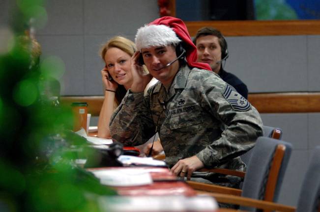 NORAD is ready to track Santa’s flight Volunteer tracker Chief Master Sgt. Roderick Schwald, North American Aerospace Defense Command and U.S. Northern Command first sergeant, answers calls from children and parents across the globe while at the NORAD Tracks Santa Operations Center on Peterson Air Force Base, Colo., on a past Christmas Eve. (Photo by Air Force Master Sgt. Chuck Marsh)