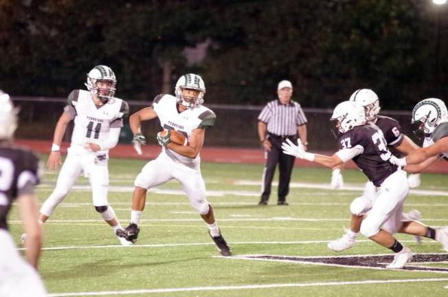 Pennridge ball carrier Taj Utsey is pursued by Delaware Valley defenders in the second quarter. Utsey scored one rushing touchdown.