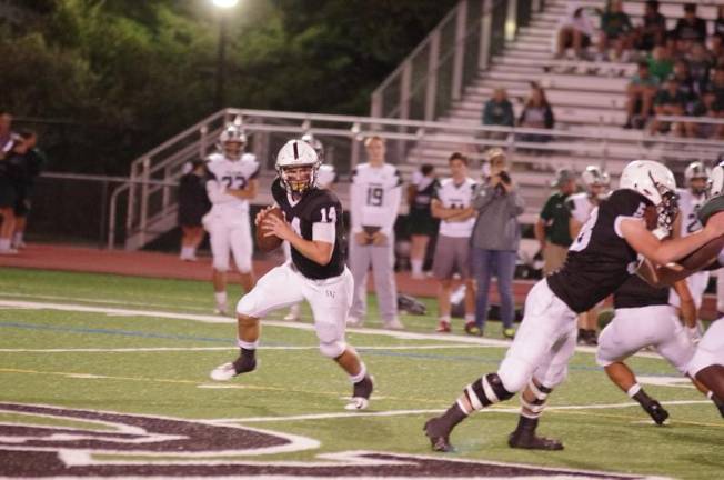 Delaware Valley quarterback Zach Scillia looks downfield for an open receiver during a roll out maneuver in the fourth quarter. Scillia completed 11 of 24 passes for 82 yards resulting in one interception.