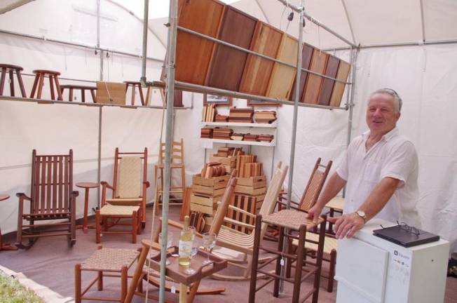 Douglas E. Starry of Gettysburg, Pa., a fourth-generation furniture craftsman, stands next to some of his creations.