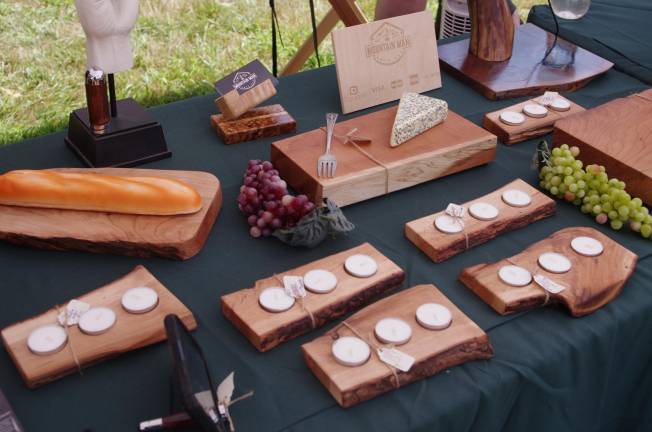 Charlie Lang, founder of Mountain Man Arts, creates customized pens, pen holders, candle holders, and cutting boards.