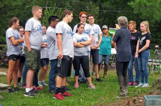 United Way volunteers learn about equine therapy Martha Dubensky, executive director of GAIT TRC, shows United Way Volunteers the new volunteer training instructional video during the Day of Caring 2015. (Photo provided)