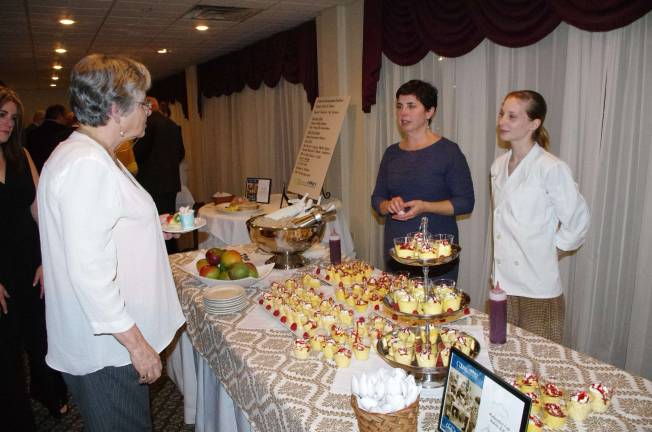Local chefs serve up dinner to raise $40,000 The Waterwheel Cafe, Bakery & Bar of Milford table.