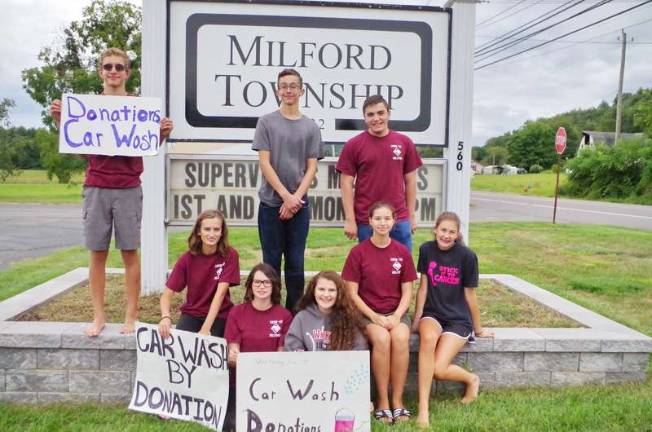 Starting in the back row from the left Venturing Crew 139 of Milford are Carson Monks (17), Ethan Monks (13), Robert Riccio (15), Katie Gandolfo (16), Gwendolyn Saski (14), Grace Gandolfo (14), Isabella Saski (16) and Olivia Gandolfo (15) advertise their car wash service.