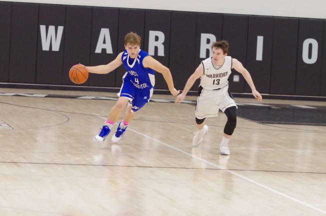 Delaware Valley Warriors meet West Scranton Invaders in 'Court Battle' West Scranton’s Cole Stetzar dribbles the ball while Delaware Valley’s Tyler Magee keeps pace. Stetzar scored 11 points. (Photo by George Leroy Hunter)