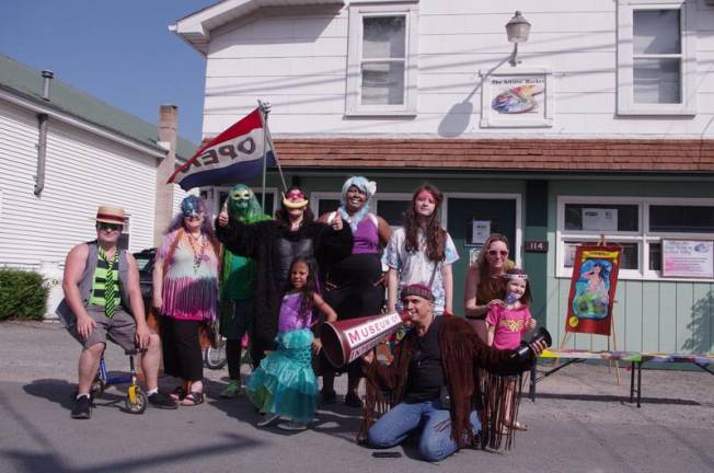 Colorful characters from the mermaid parade gathered in front of the Artists' Market in Shohola.