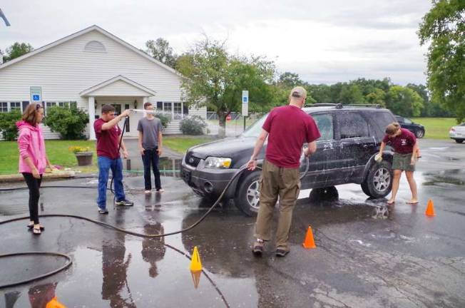 Venturing Crew 139 of Milford wash a customer's vehicle.