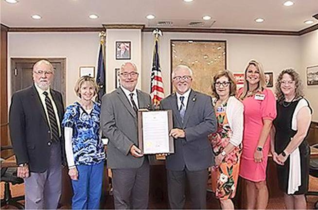 l. to r.: Pike County Commissioner Tony Waldron; Karen Arthur/WMCHC Pike Family Health Center supervisor; WMCHC Finance Director Robert Fortuner; Pike County Commissioner Matt Osterberg; WMCHC Director of Clinical Operations &amp; Quality Norma Nocilla, BSHA, LPN, CPHQ; WMCHC Administrative Director Wynter Newman; and Gail Peterson, manager Pinnacle Family Health/Pike Family Health &amp; the Tick-borne Disease &amp; Wellness Center. Missing from photo: Pike Commissioner Ron Schmalzle and WMCHC Executive Director Frederick Jackson.