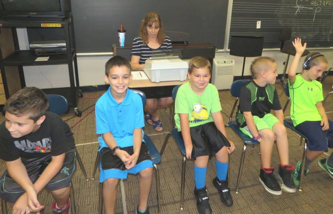 Can you hear me now? Mrs. Nan Croll (seated with testing machine) completes the hearing test on Nicholas Jorgenson (right, with headphones) as his classmates (right to left) Adam Meyer, Alexander Mills, Kyle Marsh, and William Wall wait their turn. The students are all third graders in Mrs. Jean Krisanda’s class at Delaware Valley Elementary School.