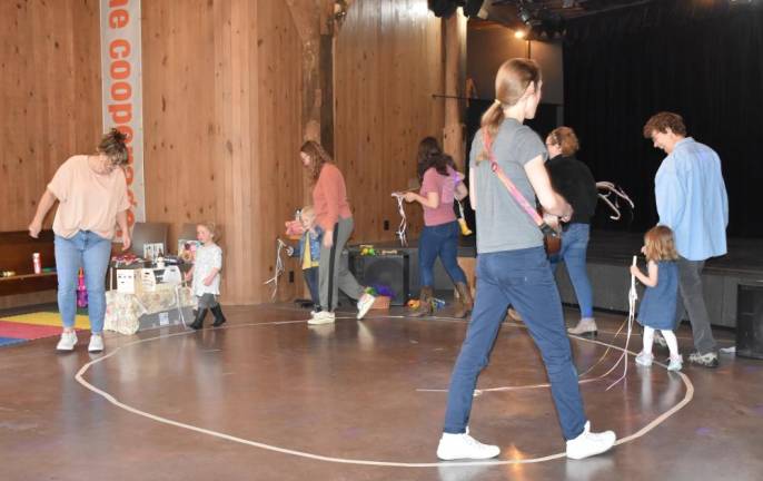 The Wayne County Family Center’s Play &amp; Learn program received a community grant from the Wayne Memorial Health Foundation in the most recent grant cycle. Shown during a recent session is instructor Peggy Jones leading children and parents in an interactive musical activity.