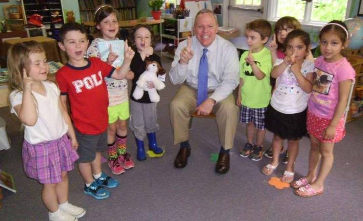 Ready early, read often Superintendent John Bell and his young friends at the Ann Street School (Photo provided)