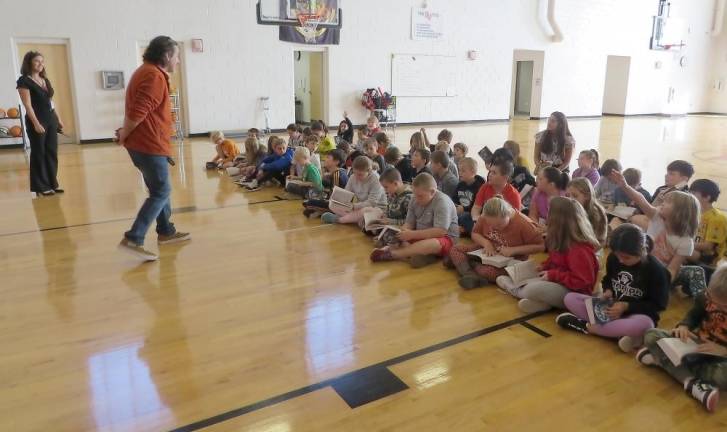 Principal Mary Ann Olsommer and Tom Murante, of Milford Matamoras Rotary Club, answering third grade students’ questions.