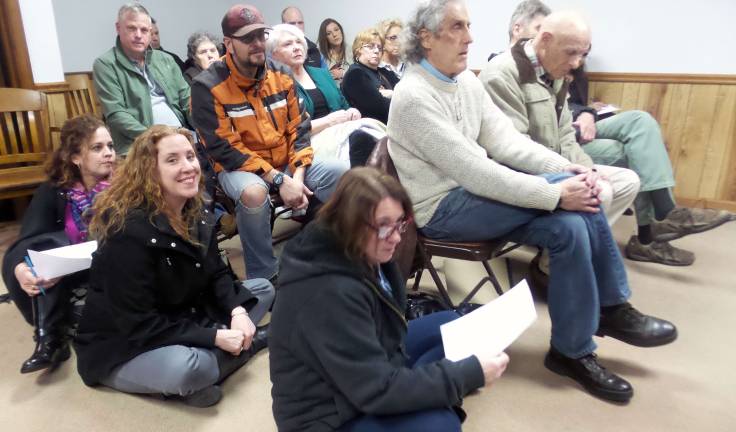 Tell us the worst: Public asks about new housing development proposed for Milford Some members of the public sat on the floor (Photo by Frances Ruth Harris)