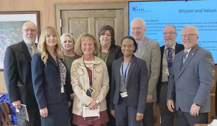 Back row (from left): Steve Gill, Program Specialist of Eastern Region Pennsylvania CASA; Marcia Reese, SAM, Inc.; Dawn Allison, CASA of Pike County Director; and Commissioners Schmalzle, Waldron, and Osterberg. Front row: Judge Kelly Gaughan; Nancy Clemens, SAM, Inc.; and Michele Burrell, Children and Youth Services Administrator (Photo provided)