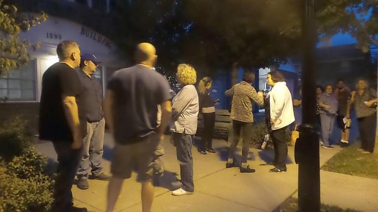 People talked with one another outside Milford Borough Hall while the Pike County Humane Society Board of Directors held an executive session at their September meeting (Photo by Frances Ruth Harris)