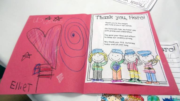 Local schoolchildren created place settings at American Legion Hall for the dinner following the ceremony.