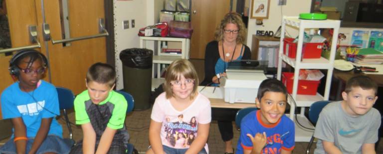 Can you hear me now? Mrs. Amy DeVrieze (seated with testing machine) completes the hearing test on Teizu Jones (left, with headphones) as her classmates Tyler Matteson, Kaeliann Wieboldt, Daniel Zuniga-Schmuck, and Lawson Finkle wait for their turn. These students are all third graders in Mrs. Jean Krisanda’s class at Delaware Valley Elementary School.