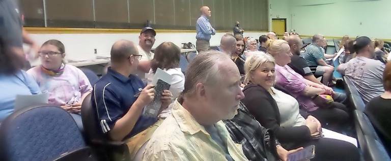 People without masks were asked by a police officer to sit on the right side of the auditorium (Photo by Frances Ruth Harris)