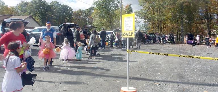 Fairy princesses mingle with ghastly ghouls at Trunk or Treat The line was long as children visited trunks (Photo by Frances Ruth Harris)