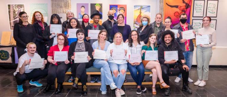 A group of students pose with certificates during the 2022 Annual Juried Student Art + Media + Design Exhibition.